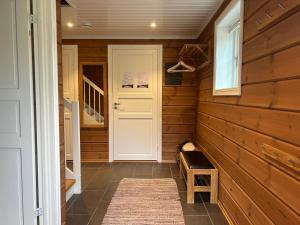 a hallway with wood paneling and a white door at Sirdal in Dirdal +31 photos