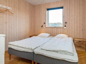 a bed in a room with a window at 5 star holiday home in Haderslev in Haderslev
