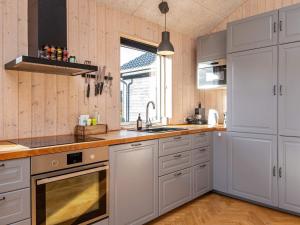a kitchen with white cabinets and a sink at 5 star holiday home in Haderslev in Haderslev