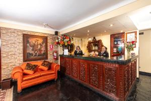 a bar with two people sitting at a counter at Hotel Agustos Cusco in Cusco