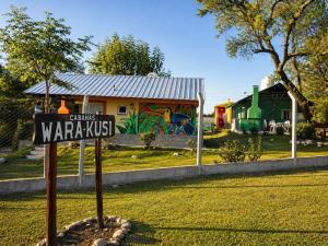 a sign in front of a yard with a playground at El Zorro Cabin Nature and Relaxation near Salta in Salta