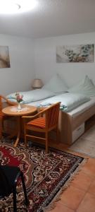 a bedroom with a bed with a table and a bed gmaxwell gmaxwell gmaxwell at Wider Apartment UG mit Tageslicht in Gottmadingen