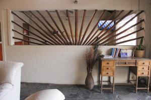 a desk with a vase next to a wall at Casa Calamo Hotel in Treinta y Tres +42 photos