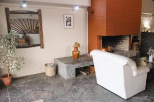 a living room with a fireplace and a white couch at Casa Calamo Hotel in Treinta y Tres