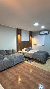 a bedroom with two beds in a room with a projector at Urban Berazategui in Berazategui