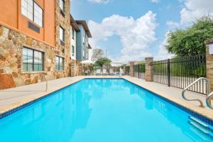 a swimming pool in front of a building at Holiday Inn Express Marble Falls by IHG in Marble Falls