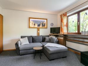 a living room with a couch and a television at Amberg in Schwoich