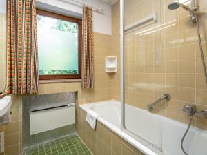 a bathroom with a tub and a shower and a sink at Amberg in Schwoich +18 photos