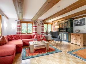 a living room with a red couch and a table at Bühelhus in Dalaas