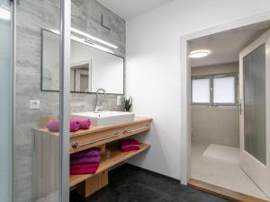a bathroom with a sink and a mirror at Bühelhus in Dalaas +38 photos