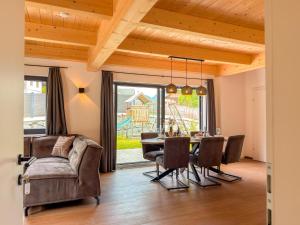 a living room with a table and chairs and a couch at Obermöschach 1 in Lake Pressegg