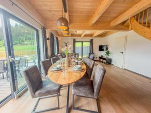 a dining room with a wooden table and chairs at Obermöschach 1B in Lake Pressegg