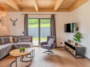 a living room with a couch and a tv at Obermöschach 1B in Lake Pressegg
