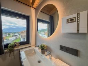 a bathroom with a sink and a large window at Obermöschach 1B in Lake Pressegg +30 photos