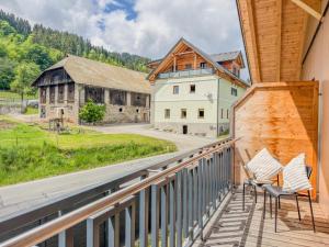 a balcony with chairs and a view of a barn at Obermöschach 1B in Lake Pressegg