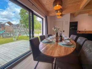 a dining room with a table and chairs and a large window at Obermöschach 1 in Lake Pressegg