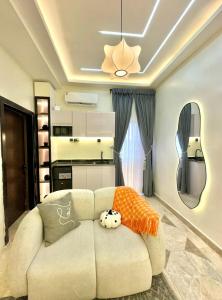 a living room with a white couch with pillows on it at Djp in Lekki