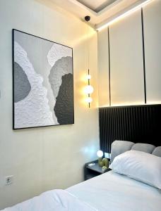 a bedroom with a bed and a picture on the wall at Djp in Lekki