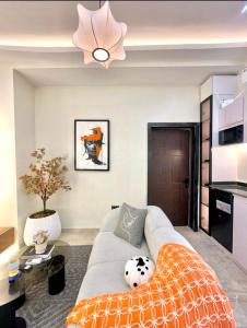 a living room with a couch and a ceiling fan at Djp in Lekki