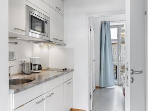 a kitchen with white cabinets and a sink at Lee in Wismar