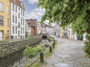 a city street with a canal and buildings at Lee in Wismar