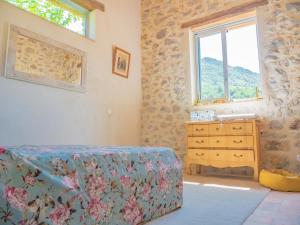 a bedroom with a bed and a dresser and a window at Le Serre des Granges Plus in Montaulieu