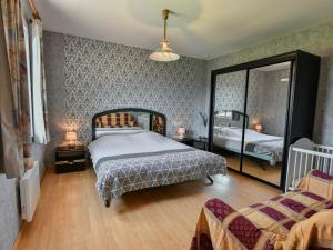 a bedroom with two beds and a large mirror at Grande Gite Bassoues in Bassoues +39 photos