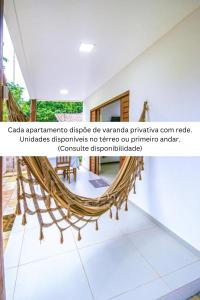 a hammock on the floor of a room at Lovely Pipa in Pipa