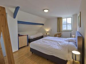a bedroom with two beds and a window at De open schuur in Elsendorp