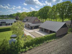 an aerial view of a house with a backyard at De open schuur in Elsendorp