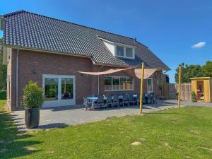a house with a patio with a table and chairs at Landzicht in Haps