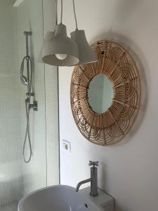 a bathroom with a mirror and a sink at Casottino presso residenza Rosso di Sera in Capoliveri +19 photos