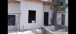 a building under construction with a window on it at Tu hostalito en Parras in Santa Isabel