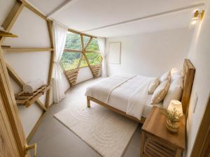 a bedroom with a bed and a window at Kayala Domes - Unique Luxury Domes in the Mountains - 4x4 recommended in La Ese +21 photos