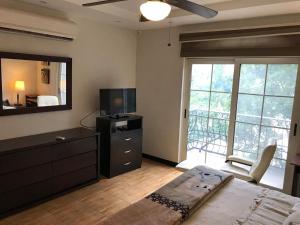 a bedroom with a bed and a dresser and a television at Edificio San Antonio in Monterrey