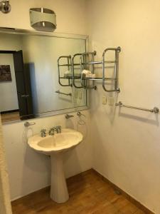 a bathroom with a sink and a mirror at Edificio San Antonio in Monterrey +18 photos