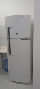 a white refrigerator freezer sitting in a kitchen at Apto aconchegante próximo à UFS in São Cristóvão