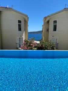a view of two buildings and a swimming pool at Adriadome Sky in Bijela
