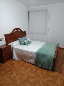 a bedroom with a bed with a pillow and a table at Casa Atalaya en Malpica in Malpica