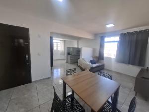 a living room with a table and a couch at Confortável & Bem Localizado! in Campo Grande +22 photos
