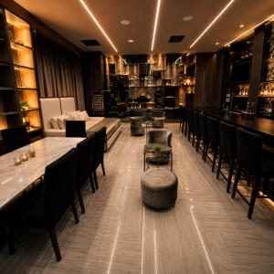 a restaurant with tables and chairs and a bar at 1Million Suites in Medellín