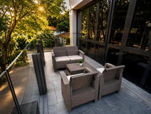 a patio with chairs and a table on a building at 1Million Suites in Medellín