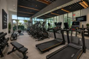 a gym with a row of treadmills and ellipticals at Splendid Executive Suites in Long Beach