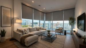 a living room with a couch and a large window at Splendid Executive Suites in Long Beach +13 photos
