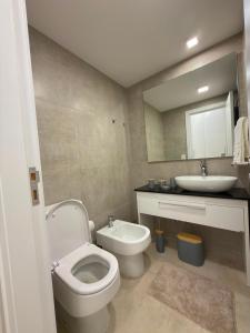 a bathroom with a toilet and a sink at Feel Premiun 2408 in Asunción +11 photos