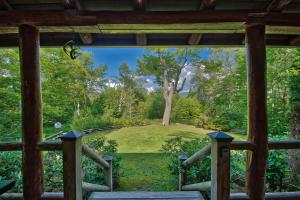 a view from the porch of a cabin with a view of a yard at Winds Aloft in Newland