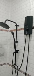 a shower with a blow dryer in a bathroom at DD HOMESTAy หาดสะพลี in Ban Tha Samet (1) +18 photos