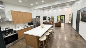 a kitchen with a counter and stools in a room at Glacier Luxury Retreat Oak Tree Apartment 3 in Hungry Horse