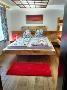 a large bed in a room with a red rug at Casa Piedro in Starnberg