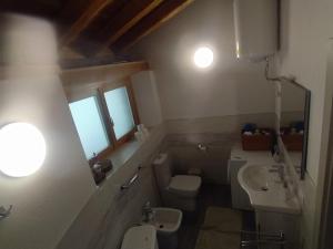 a bathroom with a toilet and a sink at La Baita nel Bosco in Berzo +13 photos